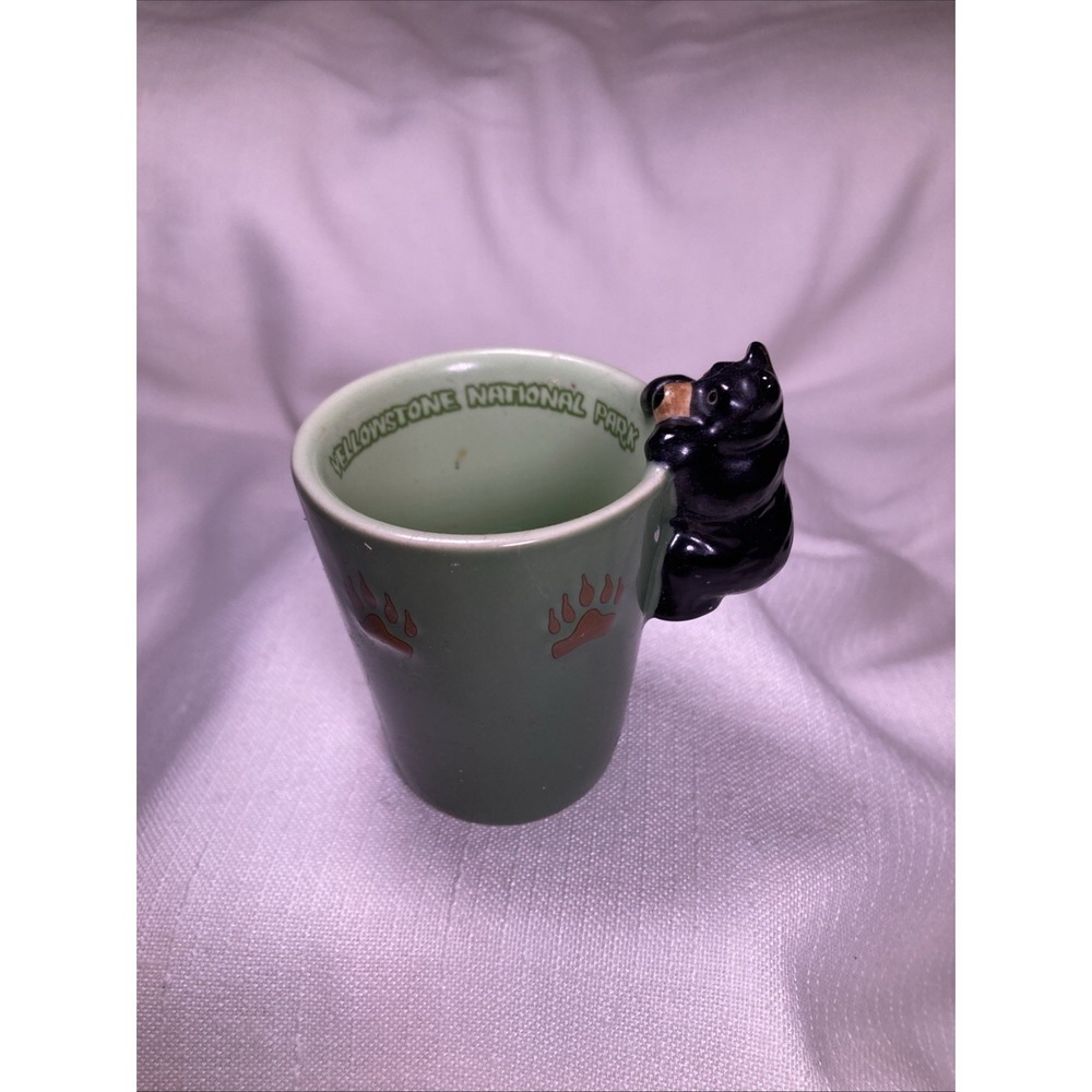 Yellowstone National Park black bear on rim with paw prints green ceramic shot